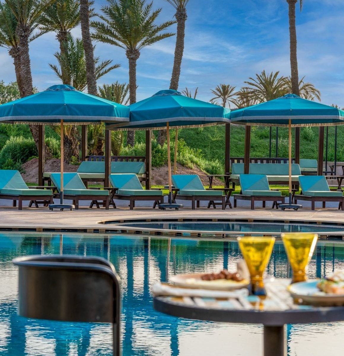 La piscine de Lumaya Garden et ses transats, à l'ombre des palmiers